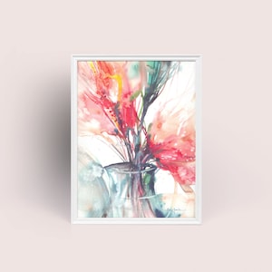 May include: Watercolour painting of vivid red and pink flowers in a clear glass vase, set against a white background. The artwork is framed in a white rectangular frame, creating a striking contrast. The painting has a soft, airy feel.