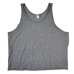 May include: A heather gray tank top with a scoop neck and wide shoulder straps. The sleeveless shirt has a tag at the neckline. The fabric appears to be a soft, lightweight material.