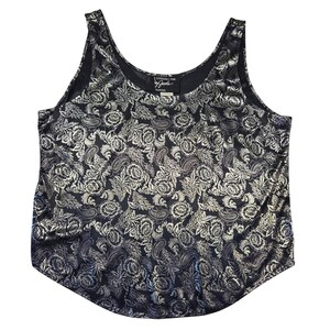 May include: Black tank top with a silver floral and paisley pattern. The top has a scoop neck and a curved hemline. The fabric has a shiny, metallic appearance. The tag reads "Especially for Jacobs".