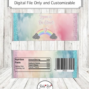 May include: A printable design for a candy bar wrapper featuring a rainbow and clouds with the text "Logan is on Cloud 9". The wrapper also includes a nutrition facts label with a barcode and the text "Ruby Rose Party Shop".