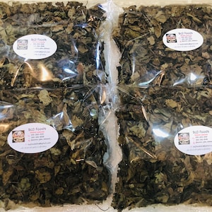 May include: Four clear plastic bags filled with dried green leaves. Each bag has a white label with the text "BOJ Foods" and contact information.