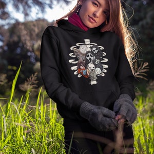 May include: Black hoodie with a white ribcage design featuring various horror movie characters. The characters include Ghostface, Freddy Krueger, Jason Voorhees, and more.