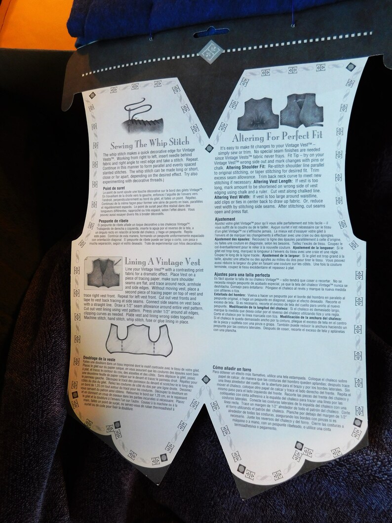 May include: A close-up of a white and black printed instruction sheet for altering and sewing a vintage vest. The instructions include diagrams and text in English, French, Spanish, Italian, and Portuguese. The text includes instructions for sewing the whip stitch, lining the vest, altering the shoulder fit, altering the vest length, altering the vest width, and adding a lining.