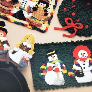 May include: Crocheted holiday-themed pot holders featuring a snowman, a clown, a pilgrim, a pilgrim woman, and a Native American woman. The pot holders are made with colorful yarn and are perfect for adding a festive touch to your kitchen.