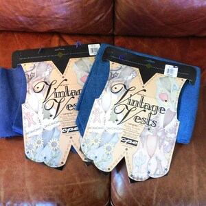 May include: Two packages of blue fabric labeled "Vintage Vests" with a whimsical design featuring sunflowers, cacti, and a gingerbread man.