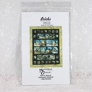 May include: A quilt pattern booklet titled Bricks, Pattern #374, A Pieced Quilt, Design by Kari Nichols. The cover features a grid-style quilt with horse imagery, framed by a yellow-green border. Mountainpeek Creations, 8210 S. Holly St.