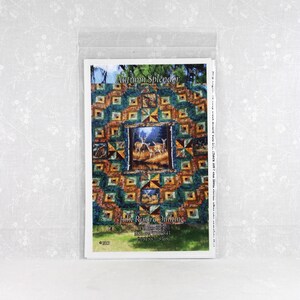 May include: A quilt pattern booklet titled Autumn Splendor by Julie Rinard Quilting. The cover features a multi-colored patchwork quilt design with green, orange, and brown tones, centered with a rectangular image of deer in a forest setting.