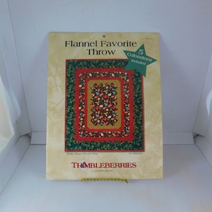 May include: A pattern for a flannel throw quilt called "Holiday Flannel Favorite Throw" by Thimbleberries. The pattern includes five color variations and measures 56 x 68 inches.