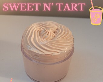 May include: A jar of light pink body cream with a swirl design on top. The jar is clear, and the text "SWEET N' TART" is above the jar. There are two cartoon images of a pink drink with ice cubes.