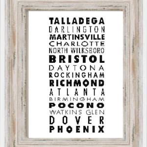 May include: A framed print featuring a list of NASCAR racetracks in black text on a white background. The racetracks listed are Talladega, Darlington, Martinsville, Charlotte, North Wilksboro, Bristol, Daytona, Rockingham, Richmond, Atlanta, Birmingham, Pocono, Watkins Glen, Dover, and Phoenix.