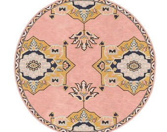 May include: A round pink rug with a geometric pattern in shades of yellow, blue, and white. The rug has a border with a repeating pattern.