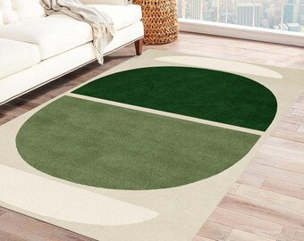 Op de afbeelding: Een geometrisch vloerkleed in groen en wit met een groot cirkelontwerp. De cirkel is verdeeld in twee secties, een groene en een witte.