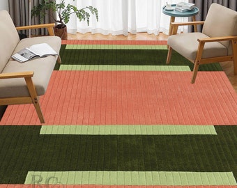 May include: A striped area rug with a green, light green, and coral color scheme. The rug has a textured, woven look.