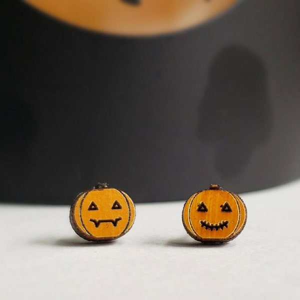Jack O Lantern stud earrings. Small pumpkin earrings for Halloween. Handmade wood with a painted shimmery orange glow. Tiny and lightweight!