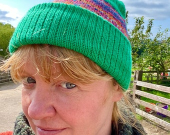 Emerald green knitted hat with orange, blue and green fairisle pattern.