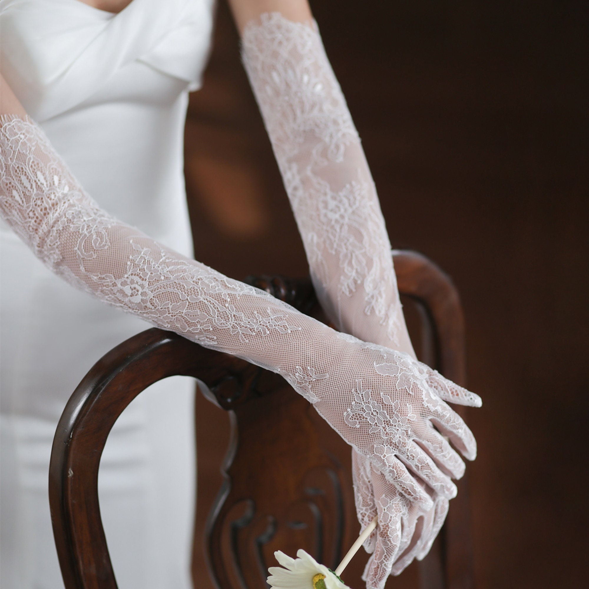 Photo of Young beautiful woman face with white lace choker and gloves