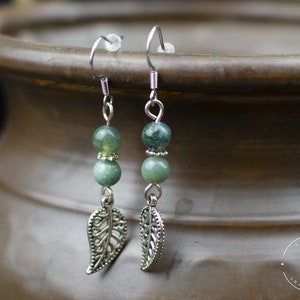 May include: A pair of silver earrings with green agate beads and silver leaf charms.