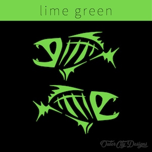 May include: Two lime green fish skeletons on a black background. The fish are facing opposite directions and have a stylized design. The text "Outer City Designs" is at the bottom of the image.