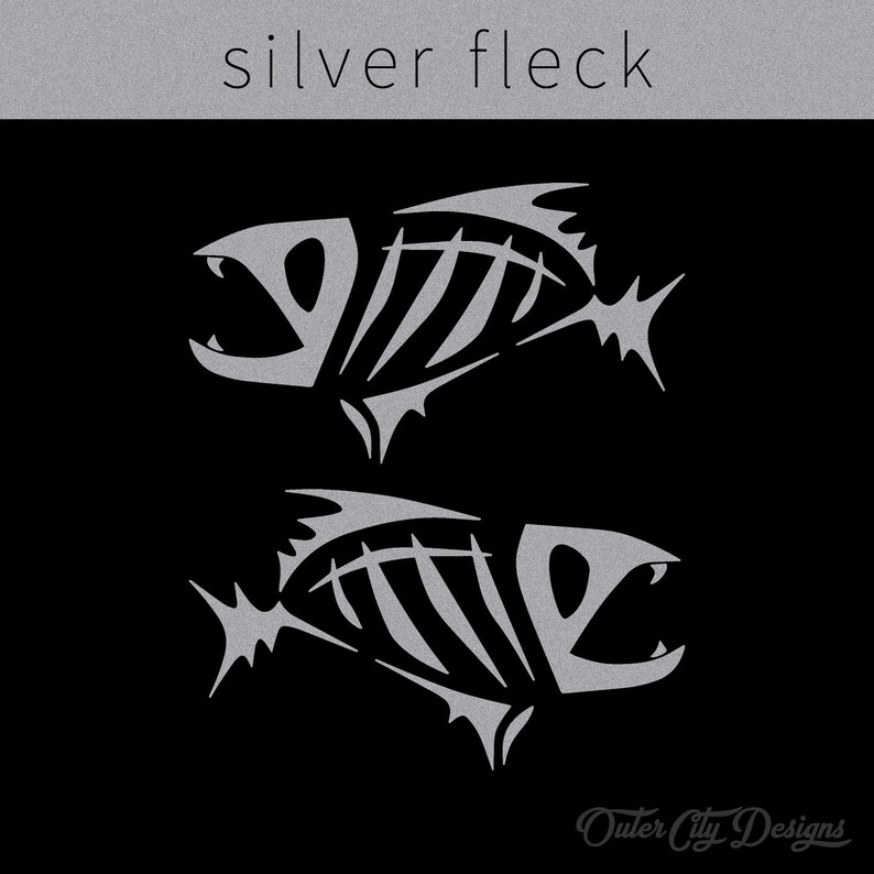 May include: Two silver fish skeletons with a textured, metallic finish on a black background. The text "silver fleck" appears above the fish. The text "Outer City Designs" appears below the fish.