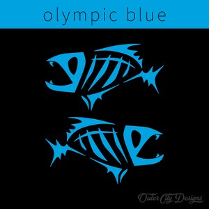 May include: Two stylized fish skeletons in a bright blue color against a black background. The text "Outer City Designs" is at the bottom of the image.