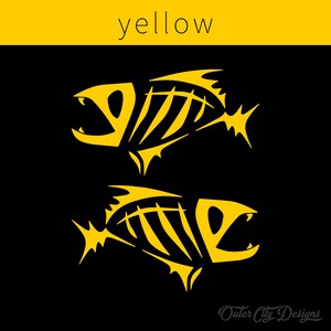 May include: Two yellow fish skeletons on a black background. The word "yellow" is written in white at the top of the image.