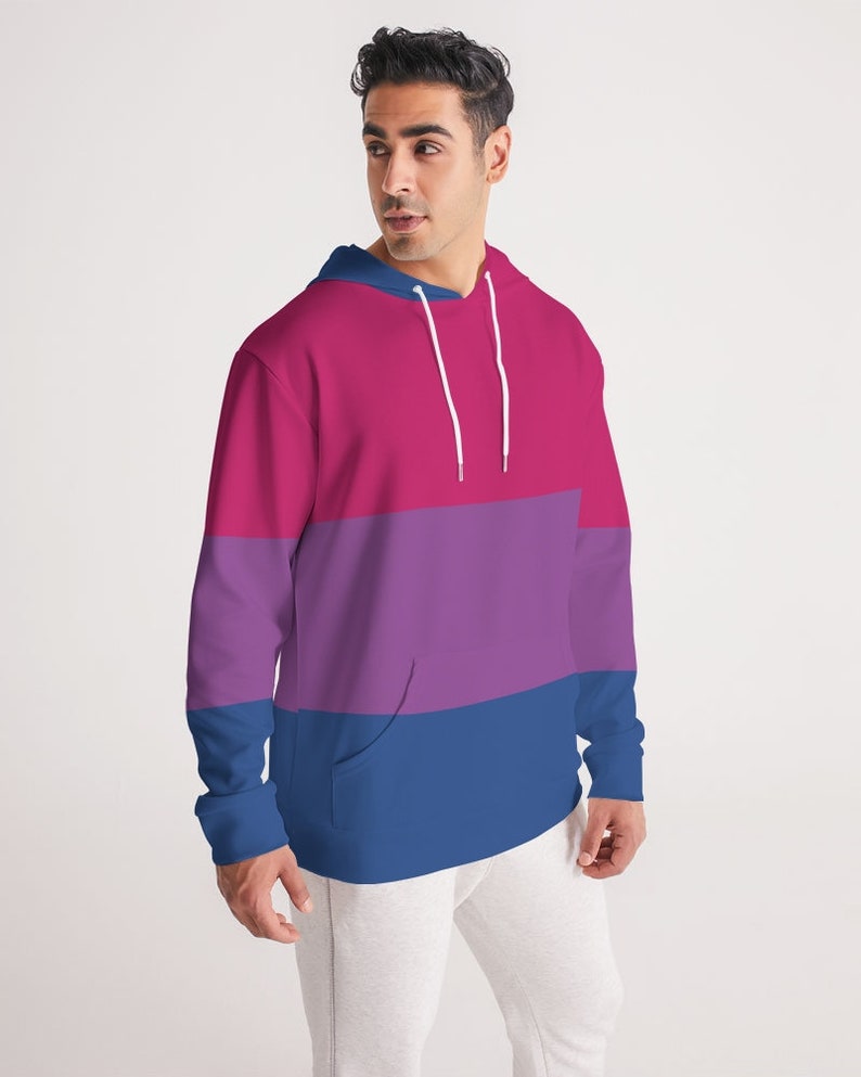 May include: A pink, purple, and blue striped hoodie with a white drawstring.