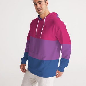 May include: A pink, purple, and blue striped hoodie with a drawstring hood.