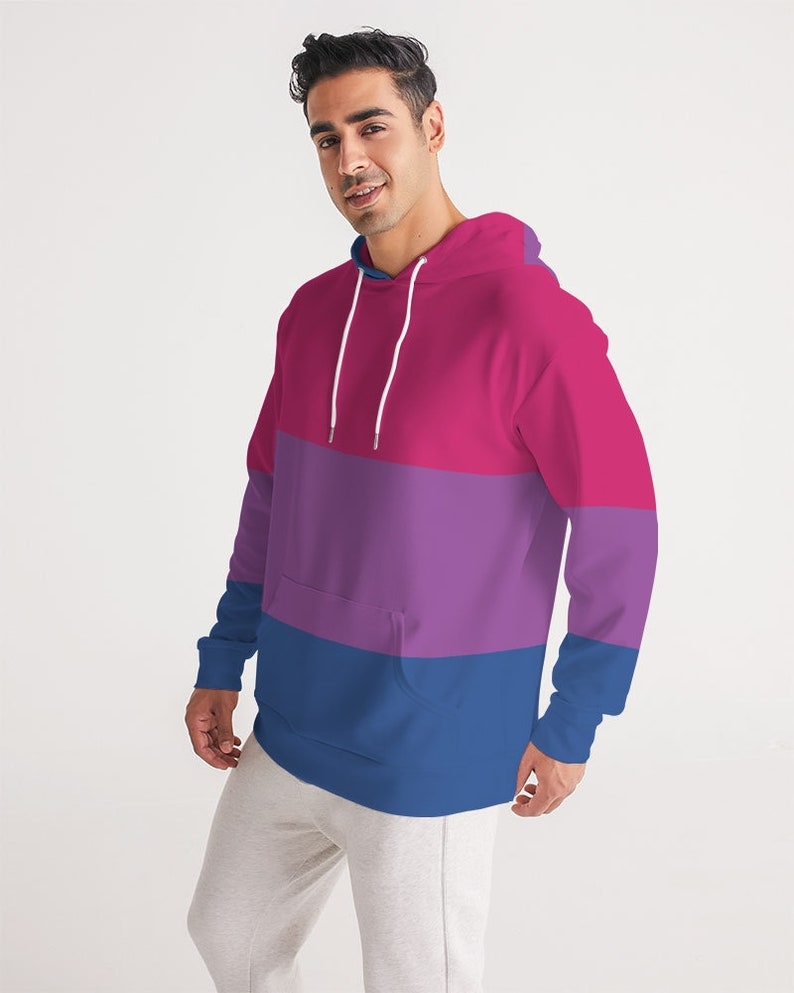 May include: A pink, purple, and blue striped hoodie with a drawstring hood.