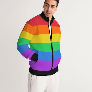 May include: A black zip-up jacket with a rainbow stripe pattern. The jacket has a stand-up collar and two pockets.