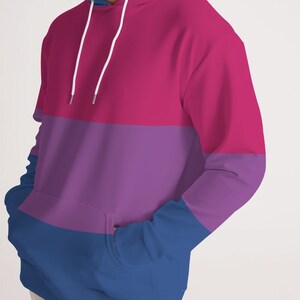 May include: A pink, purple, and blue striped hoodie with a white drawstring.