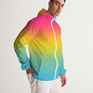 Può includere: Una giacca leggera con chiusura a zip. La giacca presenta un design sfumato con colori rosa, giallo e blu.