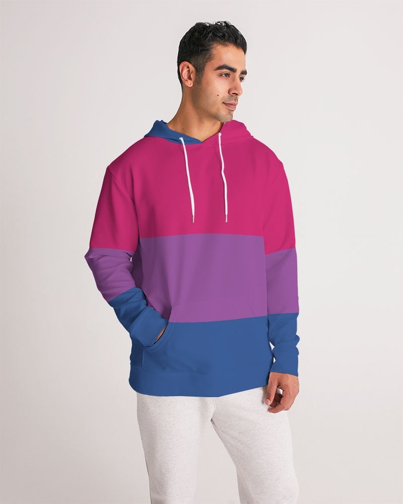 May include: A pink, purple, and blue striped hoodie with a drawstring hood.