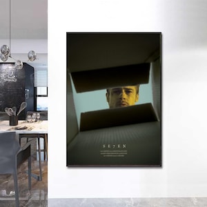 May include: A movie poster for the film "Se7en" featuring a close-up of Brad Pitt's face peering out of a box.