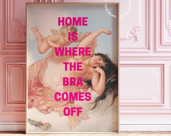 May include: A pink framed print with a painting of a woman reclining on a cloud with a cherub. The text "HOME IS WHERE THE BRA COMES OFF" is printed in pink on the print.
