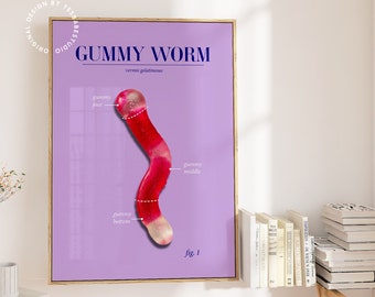 May include: A framed print featuring a detailed illustration of a gummy worm on a lavender background. The text "GUMMY WORM" and "vermis gelatinosus" are at the top. The worm is red with white sections, labeled with dotted lines.