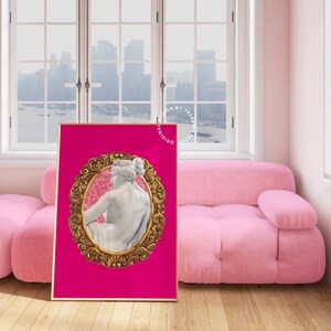 May include: A pink background with a gold ornate frame surrounding a white marble statue of a woman. The frame has a pink and white leopard print background.