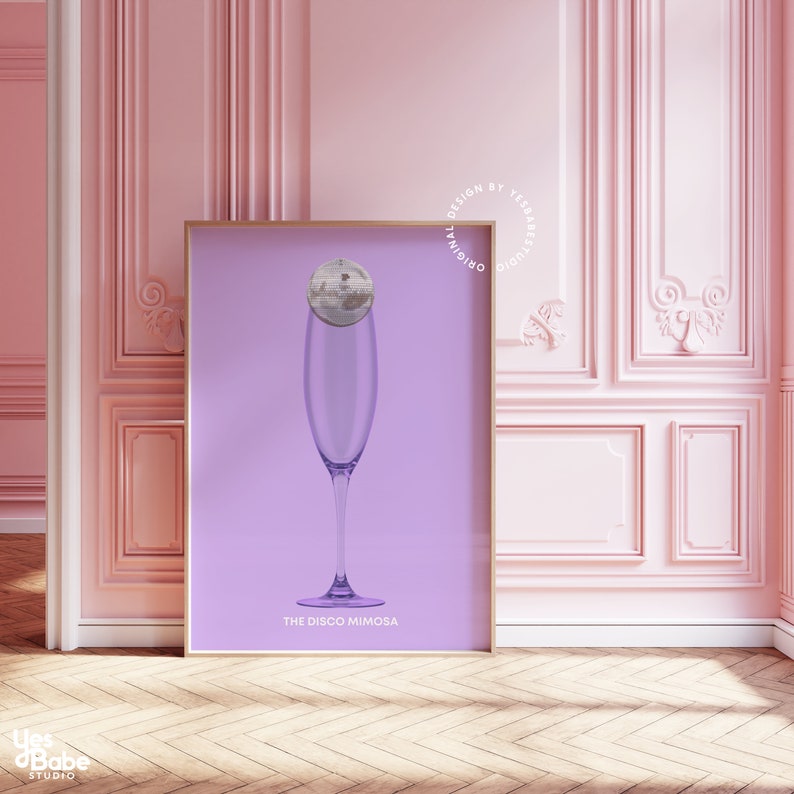 May include: A purple poster with a champagne flute filled with a disco ball. The text on the poster reads "The Disco Mimosa" and "Original Design by Yes Babe Studio".