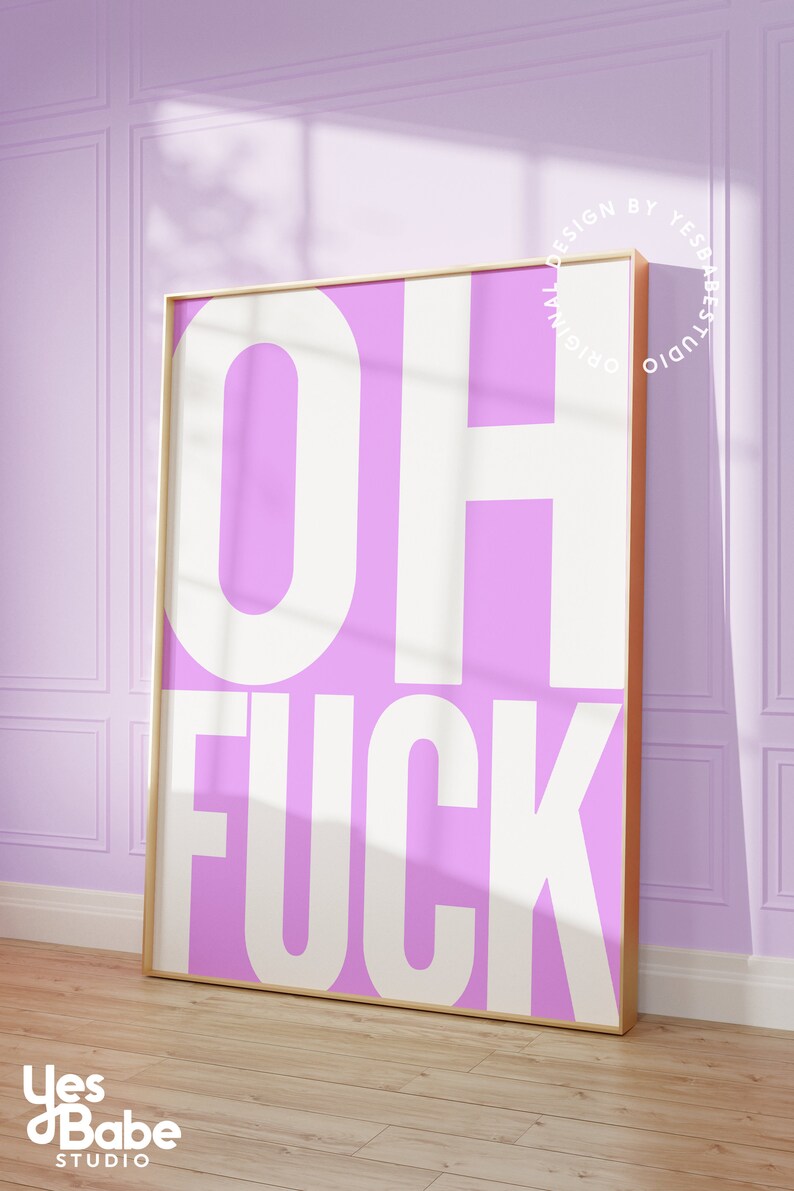 May include: A pink and white framed print with the text "OH FUCK" in white letters on a pink background.