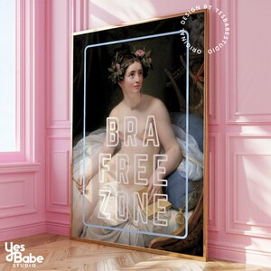 May include: A painting of a woman with a flower crown, sitting on a blue chair, holding a book. The text "BRA FREE ZONE" is superimposed on the image.