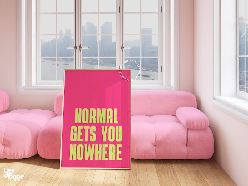 May include: A pink framed poster with the text "NORMAL GETS YOU NOWHERE" in yellow on a pink background.