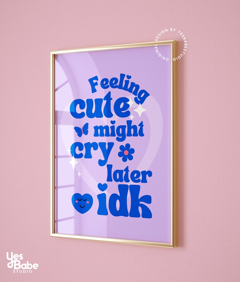 May include: A purple and blue framed print with the text "Feeling cute might cry later idk" in a retro font. The print features a heart with a smiley face and a butterfly.