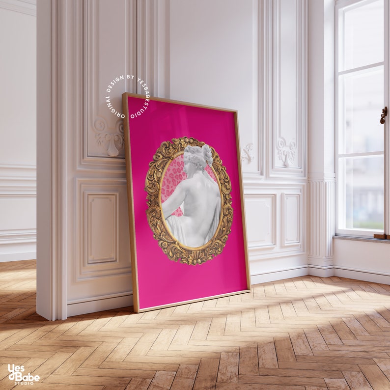 May include: A pink background with a gold ornate frame surrounding a white statue of a woman. The statue is sitting with her back to the viewer. The background inside the frame is a pink and white leopard print.