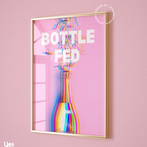 May include: A framed print with a pink background and a glitched image of a champagne bottle with the text "Bottle Fed" in white.