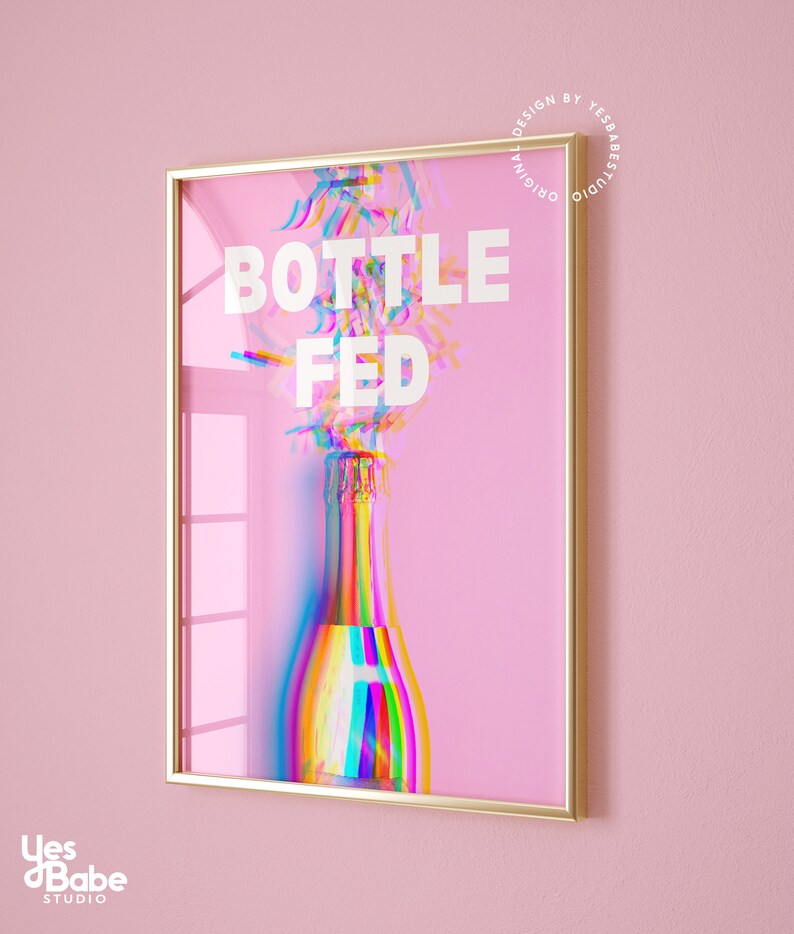 May include: A framed print with a pink background and a glitched image of a champagne bottle with the text "Bottle Fed" in white.