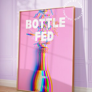 May include: A pink poster with the text "BOTTLE FED" in white letters. A rainbow-colored champagne bottle is in the center of the poster.