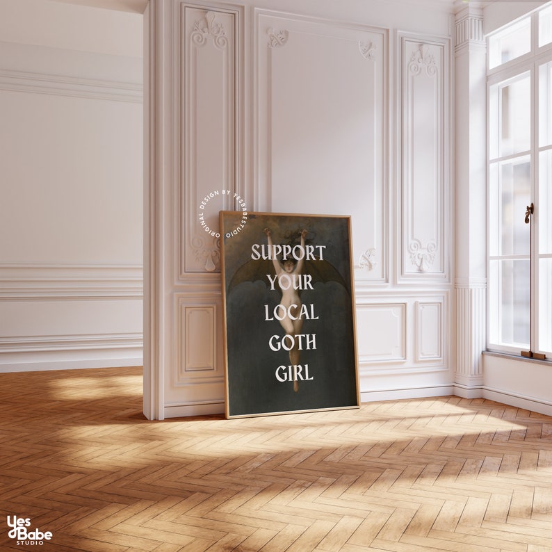 May include: A dark blue poster with a vintage illustration of a woman with wings. The text on the poster reads "Support Your Local Goth Girl".