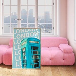 May include: A framed print with a blue and white colour scheme featuring a vintage London telephone box with the word "LONDON" repeated in white text on a light blue background.