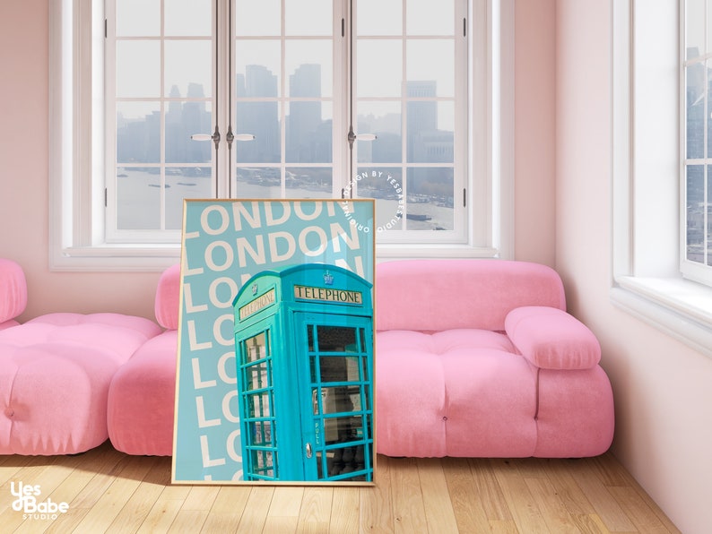 May include: A framed print with a blue and white colour scheme featuring a vintage London telephone box with the word "LONDON" repeated in white text on a light blue background.
