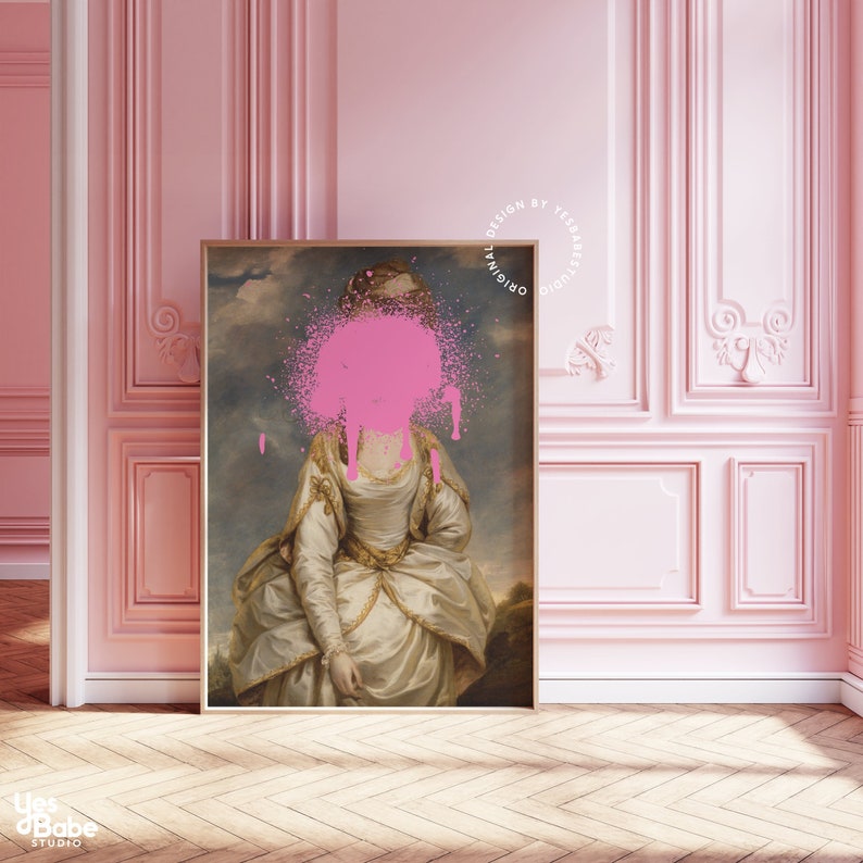 May include: A vintage portrait of a woman with a pink paint splatter covering her face. The painting is framed in a wooden frame and is hanging on a pink wall.