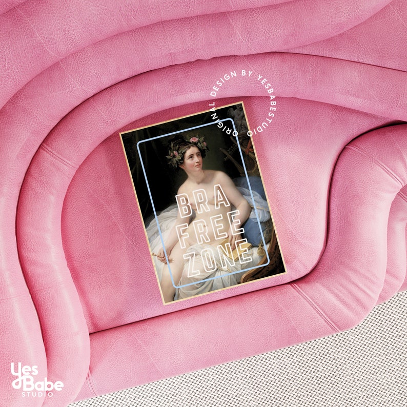 May include: A pink velvet sofa with a framed print of a woman with a floral crown. The print has the text "BRA FREE ZONE" in a neon-like font.